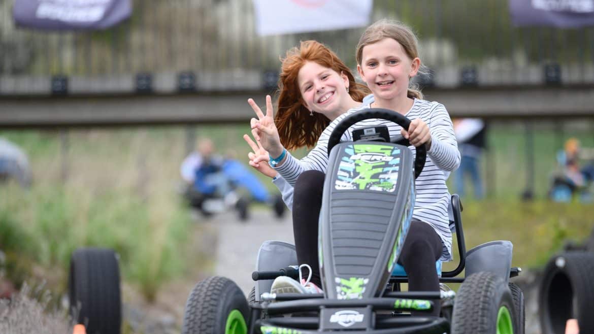 Zwei Mädchen haben Spaß auf einem BERG Zweisitzergokart